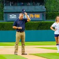 Man throwing pitch next to Detroit Tigers mascot